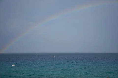 Rainbow over an ocean Stock Photos