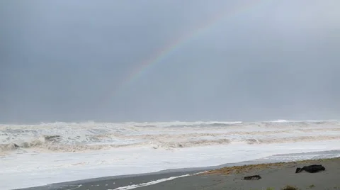 RAINBOW OVER OCEAN WAVES CRASHING ON BEACH Stock Footage 59071533