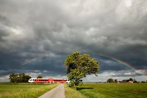 Rainbow over railroad with train Foto stock
