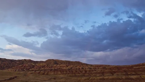Rainbow over the red colored deserts plateau. Pan shot. Stock-Footage 84820373