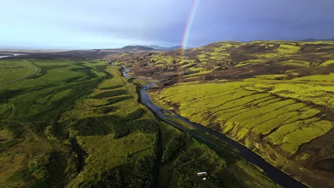 Rainbow Over River and Volcanic Moss Hills Iceland Aerial View Stock Footage 319703445
