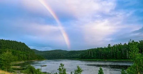 Rainbow over a River in the Wilderness Stock Photos