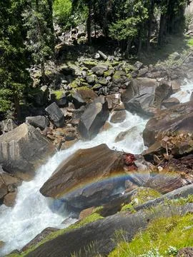 Rainbow over Rocky Stream Stock Photos