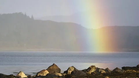 A rainbow over a Scottish loch Stock Footage 254715889