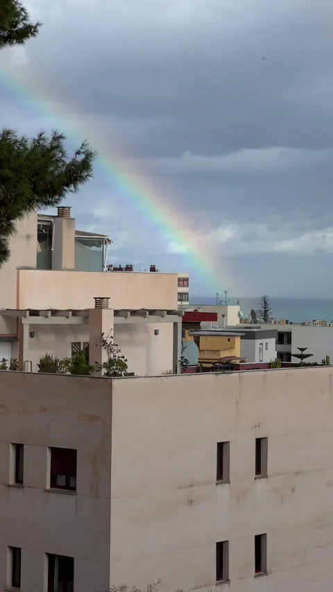 Rainbow over the sea. View from terrace in Torremolinos, Malaga, Spain. Vertical Stock Footage 240920688