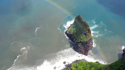 Rainbow over a small rock island at the coast of Madeira Stock Footage 151820567