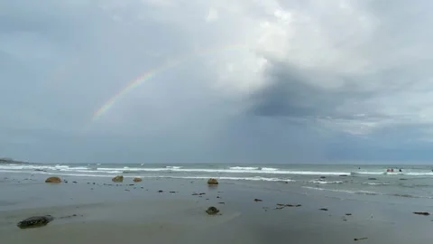Rainbow Over Stormy Ocean Beach Stock Footage