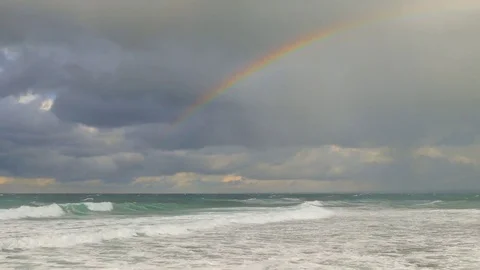 Rainbow over the stormy sea Stock Footage 85294363