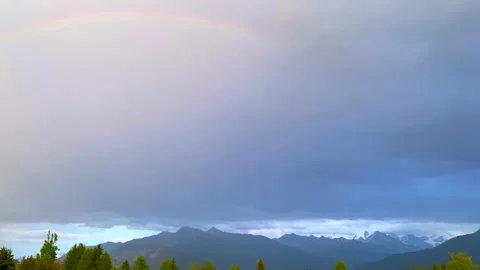 Rainbow over Swiss Typical Style House and Mountain Range Stock Footage 191951839