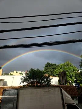 Rainbow over urban rooftops Stock Photos