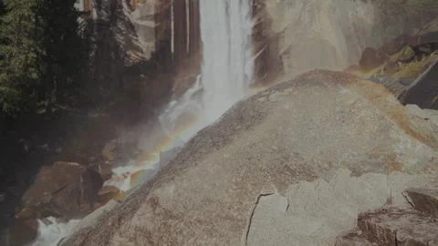 Rainbow over Vernal Fall revealed past granite boulder Stock-Footage 347986579