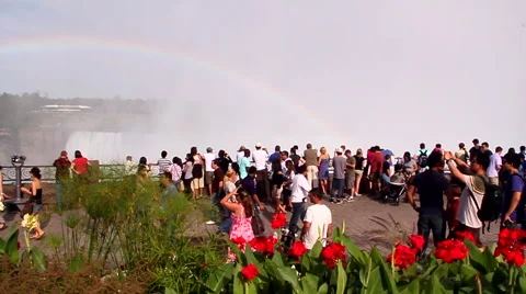 Rainbow over walking tourist Видео 42064948