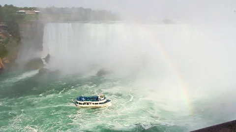Rainbow over waterfalls with boat Stock Footage 42012753