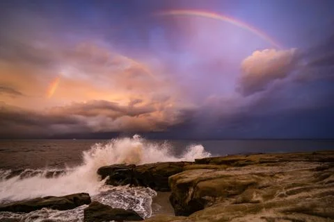 Rainbow over the waves Foto stock