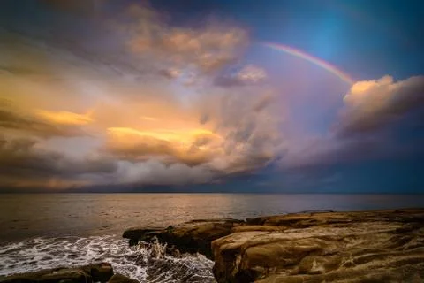 Rainbow over the waves Stock Photos