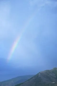 Rainbow on overcast sky Stock Photos
