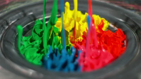 Rainbow paint bounces, splashing on a thumping speaker playing loud music Stock Footage 63996124