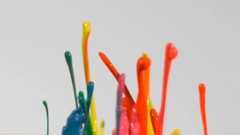 Rainbow paint splatter in front of white background Stock Photos