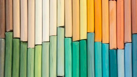 Rainbow pastel crayons in rows as background. Back to school concept Stock Photos