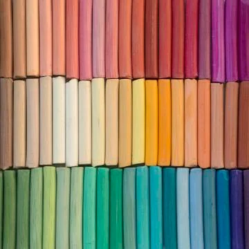 Rainbow pastel crayons in rows as background Stock Photos