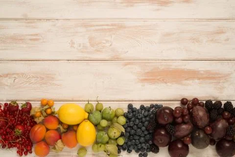 Rainbow Pattern of Fruit on Wooden Surface Stock Photos