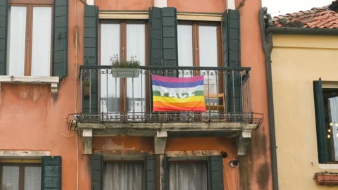 Rainbow peace flag exposed on city house facade to support stop war in Ukraine. Video stock 201528653