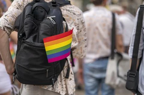 Rainbow Pride Flag Attached to Backpack at Outdoor Celebration Stock Photos
