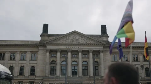 A rainbow pride flag waves in the foreground as the Christopher Street Day Stock Footage 346240092
