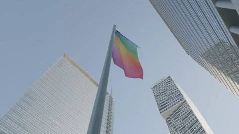 Rainbow Pride Flag Waving Above Glass Towers, Financial District, Low Angle Shot Видео 342030445