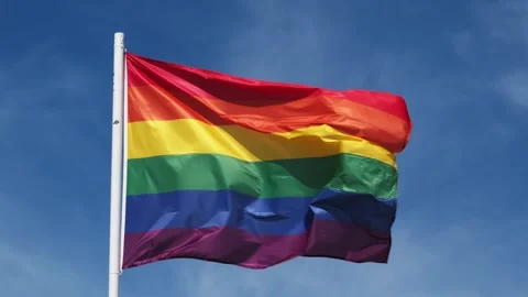 Rainbow pride flag waving in the Lisbon Portugal sky Stock Footage 344955944