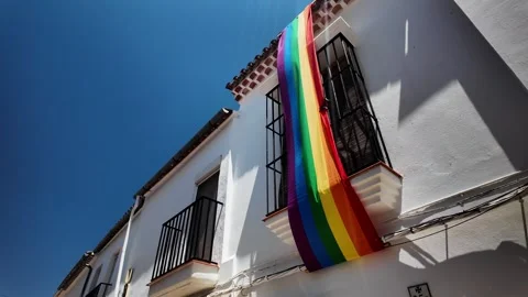 Rainbow Pride Flag on White Building, Zahara de la Sierra, Andalusia Stock Footage 346283594