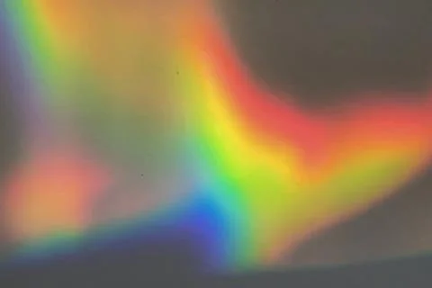 Rainbow prism reflected through water creates vibrant wavy image 15 Stock Photos