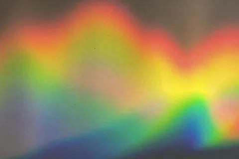 Rainbow prism reflected through water creates vibrant wavy image 11 Stock Photos