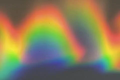 Rainbow prism reflected through water creates vibrant wavy image 7 Foto stock