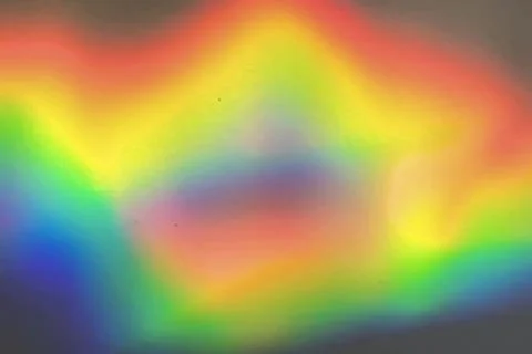 Rainbow prism reflected through water creates vibrant wavy image 2 Stock Photos