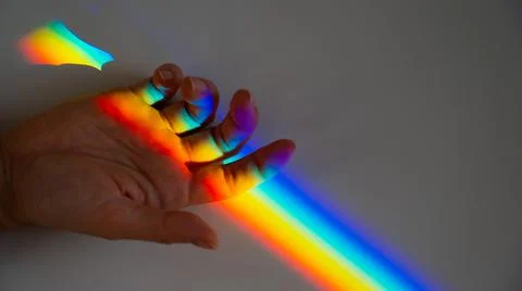 Rainbow ray on a woman's hand. Foto stock
