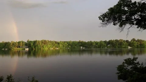 Rainbow reaching over a lake. Video stock 148676342