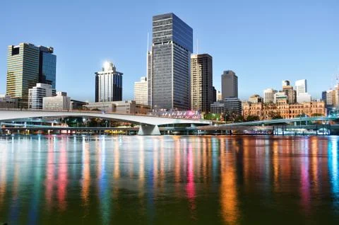 Rainbow reflection in the water of a large metropolis Stock Photos
