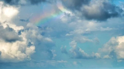Rainbow revealed by clouds in sky time lapse Stock Footage 82831213