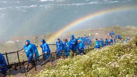 A Rainbow Rises over Tourists at the Niagara Falls Tourists - 2015 Video stock 88336691