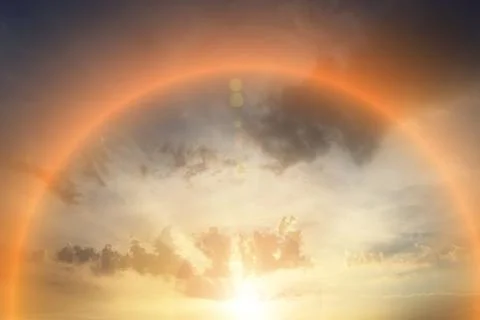 A rainbow is seen in the sky with a sun in the background Stock Photos