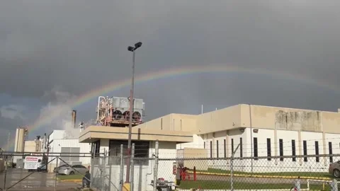 Rainbow Shining Outside Industrial Zone Building on a Cloudy Day Stock Footage 214351192