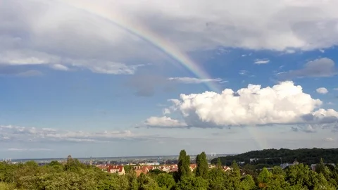 Rainbow showing up, time lapse, appearing above Gdansk Stock Footage 90113216