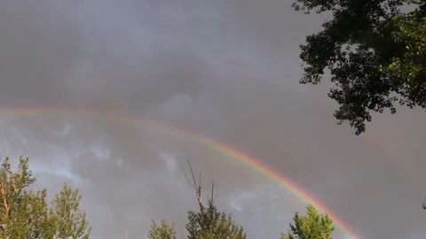 Rainbow in the sky among the clouds Video stock 137656937