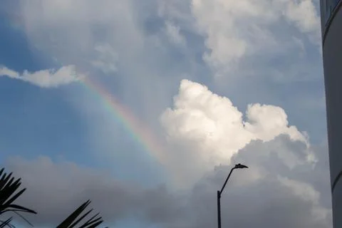 Rainbow in the sky with clouds and sun Stock Photos