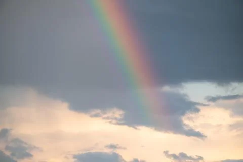 Rainbow in sky with dramatic clouds Stock Photos
