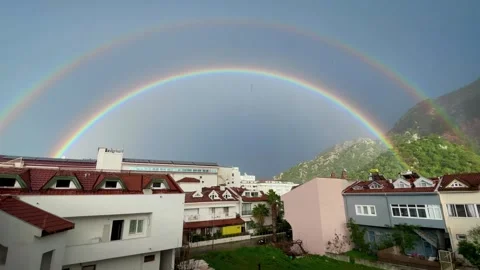 Rainbow in the sky during the rain Stock Footage 266986377