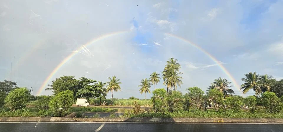 A rainbow on sky in a garden 스톡 사진