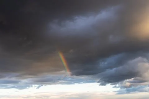 Rainbow in the sky with thunderclouds over the city Stock Photos