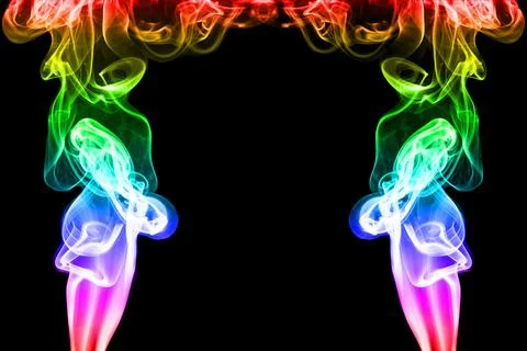 Rainbow smoke on black background Stock Photos